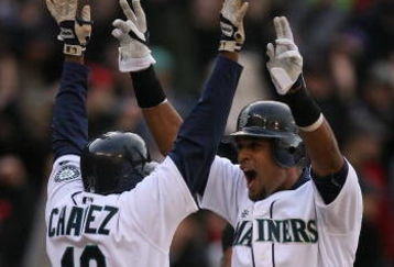 SEATTLE - APRIL 14:  Franklin Gutierrez #21 (R) of the Seattle Mariners celebrates with Endy Chavez #10 after scoring the winning run in a 3-2 win over the Los Angeles Angels of Anaheim during the Opening Day game on April 14, 2009 at Safeco Field in Seattle, Washington. (Photo by Otto Greule Jr/Getty Images)