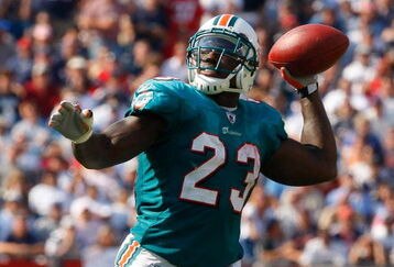 FOXBORO, MA - SEPTEMBER 21: Ronnie Brown #23 of he Miami Dolphins throws a touchdown pass in the third quarter against the New England Patriots at Gillette Stadium on September 21, 2008 in Foxboro, Massachusetts. (Photo by Jim Rogash/Getty Images)