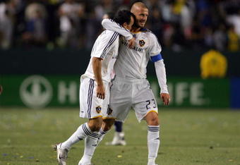 CARSON, CA - APRIL 26:  Landon Donovan #10 of the Los Angeles Galaxy is hugged by teammate David Beckham #23 after Donovan scored his third goal of the game in the second half during their MLS game against CD Chivas USA at the Home Depot Center on April 26, 2008 in Carson, California. The Galaxy defeated Chivas USA 5-2. (Photo by Victor Decolongon/Getty Images)