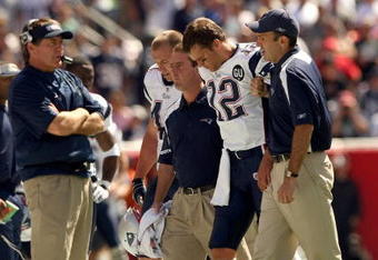 FOXBORO, MA - SEPTEMBER 7:  Quarterback Tom Brady #12 of the New England Patriots walks off the field with the aid of the Patriots staff after being injured on a play during their NFL game against the Kansas City Chiefs on September 7, 2008 at Gillette Stadium in Foxboro, Massachusetts. The Patriots defeated the Chiefs 17-10. (Photo by Elsa Garrison/Getty Images)