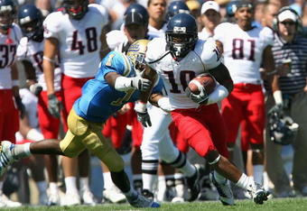 PASADENA, CA - SEPTEMBER 20:  Mike Thomas #10 of the Arizona Wildcats carries the ball for a 14 yard reception past Alterraun Verner #1 of the UCLA Bruins during the college football game at the Rose Bowl on September 20, 2008 in Pasadena, California. The Wildcats defeated the Bruins 31-10.   (Photo by Christian Petersen/Getty Images)