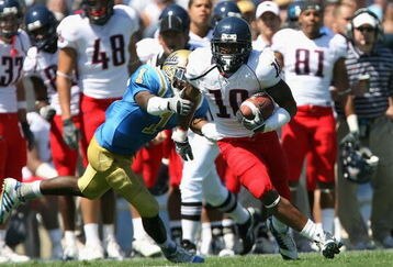 PASADENA, CA - SEPTEMBER 20:  Mike Thomas #10 of the Arizona Wildcats carries the ball for a 14 yard reception past Alterraun Verner #1 of the UCLA Bruins during the college football game at the Rose Bowl on September 20, 2008 in Pasadena, California. The Wildcats defeated the Bruins 31-10.   (Photo by Christian Petersen/Getty Images)