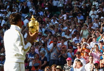 WIMBLEDON, ENGLAND - JULY 05:  Roger Federer of Switzerland celebrates victory with the trophy after the men's singles final match against Andy Roddick of USA on Day Thirteen of the Wimbledon Lawn Tennis Championships at the All England Lawn Tennis and Croquet Club on July 5, 2009 in London, England. Federer won 5-7, 7-6, 7-6, 3-6, 16-14.  (Photo by Clive Brunskill/Getty Images)