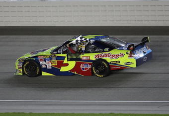 JOLIET, IL - JULY 11:  Mark Martin, driving the #5 CARQUEST/Kellogg's Chevrolet, holds the checkered flag after winning the NASCAR Sprint Cup Series LifeLock.com 400 at Chicagoland Speedway on July 11, 2009 in Joliet, Illinois.  (Photo by Jonathan Daniel/Getty Images)