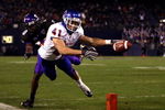 SAN DIEGO, CA - DECEMBER 23:  Runningback Ian Johnson #41 of the Boise State Broncos dives for the endzone pilon against the defense of Cornerback Rafael Priest #10 of TCU during the San Diego County Credit Union Poinsettia Bowl at Qualcomm Stadium on December 23, 2008 in San Diego, California. (Photo by Donald Miralle/Getty Images)
