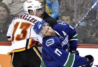 VANCOUVER, CANADA - OCTOBER 9:  Ryan Kesler #17 of the Vancouver Canucks reacts after getting hit in the face by Mike Cammalleri #13 of the Calgary Flames during their game at General Motors Place October 9, 2008 in Vancouver, Canada.   (Photo by Nick Didlick/Getty Images)
