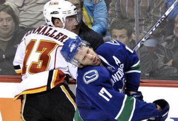 VANCOUVER, CANADA - OCTOBER 9:  Ryan Kesler #17 of the Vancouver Canucks reacts after getting hit in the face by Mike Cammalleri #13 of the Calgary Flames during their game at General Motors Place October 9, 2008 in Vancouver, Canada.   (Photo by Nick Didlick/Getty Images)