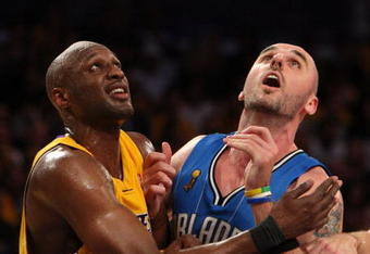 LOS ANGELES, CA - JUNE 04:  Lamar Odom #7 of the Los Angeles Lakers and Marcin Gortat #13 of the Orlando Magic battle for positon in the fourth quarter of Game One of the 2009 NBA Finals at Staples Center on June 4, 2009 in Los Angeles, California. NOTE TO USER: User expressly acknowledges and agrees that, by downloading and or using this photograph, User is consenting to the terms and conditions of the Getty Images License Agreement.  (Photo by Jed Jacobsohn/Getty Images)