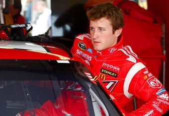 JOLIET, IL - JULY 10: Kasey Kahne, driver of the #9 Budweiser Dodge, climbs into his car prior to practice for the NASCAR Sprint Cup Series LifeLock.com 400 at Chicagoland Speedway on July 10, 2009 in Joliet, Illinois.  (Photo by Geoff Burke/Getty Images for NASCAR)