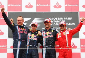 NURBURG, GERMANY - JULY 12:  Mark Webber (2nd right) of Australia and Red Bull Racing celebrates with third placed Felipe Massa (right) of Brazil and Ferrari, second placed Sebastian Vettel (2nd left) of Germany and Red Bull Racing and Red Bull Racing Team Manager Jonathan Wheatley on the podium after winning the German Formula One Grand Prix at Nurburgring on July 12, 2009 in Nurburg, Germany.  (Photo by Mark Thompson/Getty Images)