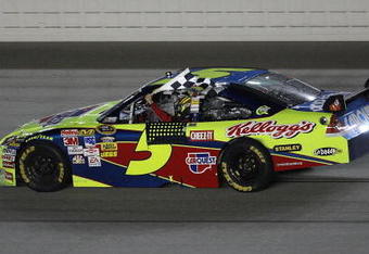 JOLIET, IL - JULY 11:  Mark Martin, driving the #5 CARQUEST/Kellogg's Chevrolet, holds the checkered flag after winning the NASCAR Sprint Cup Series LifeLock.com 400 at Chicagoland Speedway on July 11, 2009 in Joliet, Illinois.  (Photo by Jonathan Daniel/Getty Images)