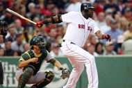 BOSTON - JULY 07:  David Ortiz #34 of the Boston Red Sox hits a single as Kurt Suzuki #8 of the Oakland Athletics defends on July 7, 2009 at Fenway Park in Boston, Massachusetts.  (Photo by Elsa/Getty Images)