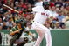 BOSTON - JULY 07: David Ortiz #34 of the Boston Red Sox hits a single as Kurt Suzuki #8 of the Oakland Athletics defends on July 7, 2009 at Fenway Park in Boston, Massachusetts. (Photo by Elsa/Getty Images)