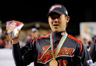 LOS ANGELES, CA - MARCH 23:  Daisuke Matsuzaka #18 of Japan holds up the the MVP trophy after defeating Korea during the finals of the 2009 World Baseball Classic on March 23, 2009 at Dodger Stadium in Los Angeles, California. Japan won 5-3 in 10 innings.  (Photo by Kevork Djansezian/Getty Images)