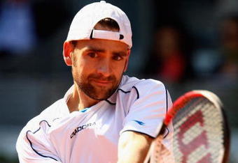MADRID, SPAIN - MAY 10:  Nicolas Kiefer of Germany plays a backhand against Tommy Robredo of Spain in their first round match during the Madrid Open tennis tournament at the Caja Magica on May 10, 2009 in Madrid, Spain.  (Photo by Clive Brunskill/Getty Images)
