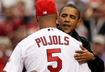 ST LOUIS, MO - JULY 14:  U.S. President Barack Obama waves hugs Albert Pujols of the St. Louis Cardinals after throwing out the first pitch at the 2009 MLB All-Star Game at Busch Stadium on July 14, 2009 in St Louis, Missouri.  (Photo by Jamie Squire/Getty Images)