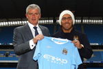 MANCHESTER, ENGLAND - JULY 14:  Mark Hughes, manager of Manchester City, poses with Carlos Tevez after he signed for Manchester City at City of Manchester Stadium on July 14, 2009 in Manchester, England.  (Photo by Matthew Lewis/Getty Images)