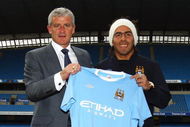 MANCHESTER, ENGLAND - JULY 14:  Mark Hughes, manager of Manchester City, poses with Carlos Tevez after he signed for Manchester City at City of Manchester Stadium on July 14, 2009 in Manchester, England.  (Photo by Matthew Lewis/Getty Images)