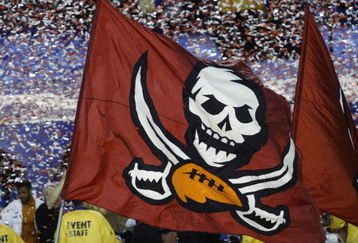 SAN DIEGO - JANUARY 26:  A Tampa Bay Buccaneers flag waves in front of a storm of confetti after the victory over the Oakland Raiders in Super Bowl XXXVII on January 26, 2003 at Qualcomm Stadium in San Diego, California.  The Buccaneers won 48-21.  (Photo by Stephen Dunn/Getty Images)