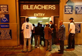 NEW YORK - SEPTEMBER 21: Fans watch the game from the street through the bleachers entrance during the last game at Yankee Stadium between the Baltimore Orioles and the New York Yankees on September 21, 2008 at Yankee Stadium in the Bronx borough of New York City. Yankee Stadium held it's inaugural game on April 18, 1923 against the Boston Red Sox and tonight's match will be the final game to be played at the historic stadium. During it's 85 years as ''The Home of Champions,'' the stadium has also been known as ''The House that Ruth Built'' and ''The Cathedral.'' The stadium has been host to 33 World Series, three Papal visits and has been visited by legends such as Babe Ruth, Joe DiMaggio, Yogi Bera, Mickey Mantle and boxing great Muhummad Ali. In 2009 the Yankees will move across the street to a newly constructed stadium estimated to cost $1.3 billion. (Photo by Chris McGrath/Getty Images)