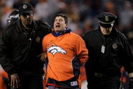 DENVER - NOVEMBER 23:  A fan is forcibly removed from the field after running onto the field during the fourth quarter as the Oakland Raiders faced the Denver Broncos during week 12 NFL action at Invesco Field at Mile High on November 23, 2008 in Denver, Colorado. The Raiders defeated the Broncos 31-10.  (Photo by Doug Pensinger/Getty Images)