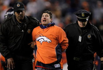 DENVER - NOVEMBER 23:  A fan is forcibly removed from the field after running onto the field during the fourth quarter as the Oakland Raiders faced the Denver Broncos during week 12 NFL action at Invesco Field at Mile High on November 23, 2008 in Denver, Colorado. The Raiders defeated the Broncos 31-10.  (Photo by Doug Pensinger/Getty Images)
