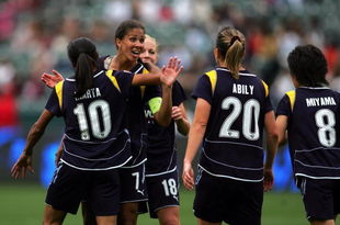 CARSON, CA - MARCH 29:  Shannon Boxx #7 and Katie Larkin #18 of the Los Angeles Sol look to teammate Camille Abily #20 to celebrate Abily's second half goal against the Washington Freedom during their inaugural WPS match at The Home Depot Center on March 29, 2009 in Carson, California. The Sol defeated the Freedom 2-0.  (Photo by Victor Decolongon/Getty Images)