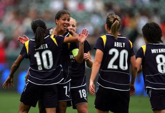 CARSON, CA - MARCH 29:  Shannon Boxx #7 and Katie Larkin #18 of the Los Angeles Sol look to teammate Camille Abily #20 to celebrate Abily's second half goal against the Washington Freedom during their inaugural WPS match at The Home Depot Center on March 29, 2009 in Carson, California. The Sol defeated the Freedom 2-0.  (Photo by Victor Decolongon/Getty Images)