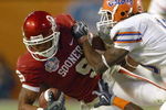 MIAMI - JANUARY 08:  Juaquin Iglesias #9 of the Oklahoma Sooners carries the ball against Ahmed Black #35 and Will Hill #10 of the Florida Gators during the FedEx BCS National Championship Game at Dolphin Stadium on January 8, 2009 in Miami, Florida.  (Photo by Donald Miralle/Getty Images)