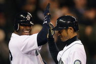SEATTLE - APRIL 15:  Ichiro Suzuki (R) of the Seattle Mariners is congratulated by Ken Griffey, Jr. after hitting a grand slam against the Los Angeles Angels of Anaheim at Safeco Field April 15, 2009 in Seattle, Washington. The hit tied Suzuki with Isao Harimoto, the current all-time hits leader among Japanese players. All Major League Baseball players are wearing #42 in honor of Jackie Robinson day.  (Photo by Otto Greule Jr/Getty Images)