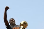 LOS ANGELES, CA - JUNE 17:  Kobe Bryant #24 holds the Larry O'Brien trophy and waves to the crowd from the top of a double decker bus at the start of the Los Angeles Lakers NBA championship victory parade outside the Staples Center on June 17, 2009 in Los Angeles, California.  (Photo by Stephen Dunn/Getty Images)
