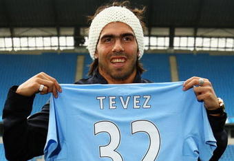 MANCHESTER, ENGLAND - JULY 14:  Carlos Tevez poses as he is unveilled at the City of Manchester Stadium after signing for Manchester City on July 14, 2009 in Manchester, England.  (Photo by Matthew Lewis/Getty Images)