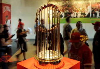 ANAHEIM, CA - APRIL 06:  Fans look at the 2002 World Series trophy of Los Angeles Angels at Angels Stadium of Anaheim after the gates opened for the Los Angeles Angels home opener against the Oakland Athletics on opening day April 6, 2009 in Anaheim, California.  (Photo by Kevork Djansezian/Getty Images)