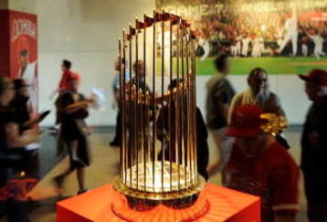 ANAHEIM, CA - APRIL 06:  Fans look at the 2002 World Series trophy of Los Angeles Angels at Angels Stadium of Anaheim after the gates opened for the Los Angeles Angels home opener against the Oakland Athletics on opening day April 6, 2009 in Anaheim, California.  (Photo by Kevork Djansezian/Getty Images)