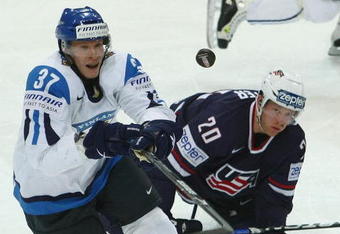 BERN, SWITZERLAND - MAY 06:  Mika Pyorala of Finland takes the puck from Ryan Suter of USA during the IIHF World Championship Quarter-Final between Finland and USA at the PostFinance Arena on May 6, 2009 in Bern, Switzerland.  (Photo by Mike Hewitt/Getty Images)