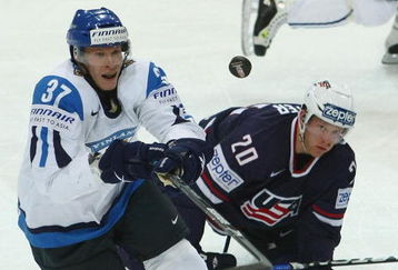 BERN, SWITZERLAND - MAY 06:  Mika Pyorala of Finland takes the puck from Ryan Suter of USA during the IIHF World Championship Quarter-Final between Finland and USA at the PostFinance Arena on May 6, 2009 in Bern, Switzerland.  (Photo by Mike Hewitt/Getty Images)