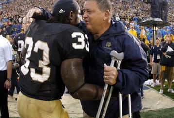SOUTH BEND, IN - SEPTEMBER 13:  Head coach Charlie Weis of the Notre Dame Fighting Irish is congratulated by Robert Hughes #33 during the final seconds of their 35-17 victory over the Michigan Wolverines on September 13, 2008 at Notre Dame Stadium in South Bend, Indiana.  (Photo by Gregory Shamus/Getty Images)
