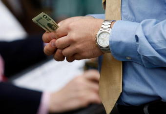 LOUISVILLE, KY - MAY 02:  A race fan holds money during the 135th running of the Kentucky Derby on May 2, 2009 at Churchill Downs in Louisville, Kentucky.  (Photo by Jamie Squire/Getty Images)