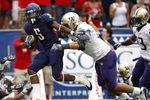 TUCSON, AZ - OCTOBER 04:  Nic Grigsby #5 of the Arizona Wildcats tries to escape the tackle of Daniel Te'o-Nesheim #66 of the Washington Huskies during a first quarter run on October 4, 2008 at Arizona Stadium in Tucson, Arizona.  (Photo by Gregory Shamus/Getty Images)