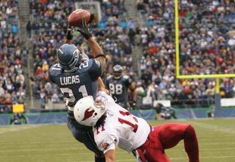 SEATTLE - DECEMBER 26:  Ken Lucas #21 of the Seattle Seahawks intercepts this pass in the end zone against Wide Receiver Larry Fitzgerald #11 of the Arizona Cardinals at Qwest Field December 26, 2004 in Seattle, Washington. (Photo by Otto Greule Jr/Getty Images)