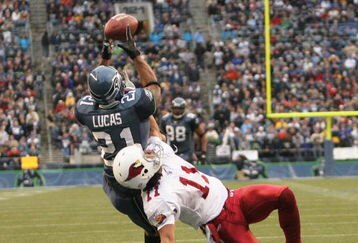 SEATTLE - DECEMBER 26:  Ken Lucas #21 of the Seattle Seahawks intercepts this pass in the end zone against Wide Receiver Larry Fitzgerald #11 of the Arizona Cardinals at Qwest Field December 26, 2004 in Seattle, Washington. (Photo by Otto Greule Jr/Getty Images)