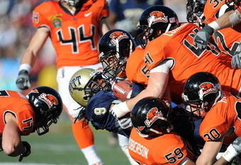 EL PASO, TX - DECEMBER 31:  T.J. Porter #9 of the Pittsburgh Panthers is tackled by Cameron Collins #5 of the Oregon State Beavers during the Brut Sun Bowl on December 31, 2008 at the Sun Bowl in El Paso, Texas.  (Photo by Ronald Martinez/Getty Images)