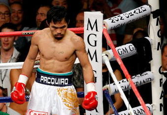 LAS VEGAS - MAY 02:  Manny Pacquiao of the Philippines looks down at referee Kenny Bayless counting after Ricky Hatton of England was knocked down in the first round during their junior welterweight title fight at the MGM Grand Garden Arena May 2, 2009 in Las Vegas, Nevada.  (Photo by Ethan Miller/Getty Images)
