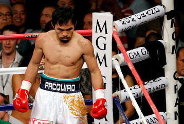 LAS VEGAS - MAY 02:  Manny Pacquiao of the Philippines looks down at referee Kenny Bayless counting after Ricky Hatton of England was knocked down in the first round during their junior welterweight title fight at the MGM Grand Garden Arena May 2, 2009 in Las Vegas, Nevada.  (Photo by Ethan Miller/Getty Images)