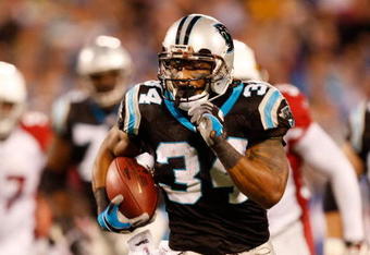 CHARLOTTE, NC - JANUARY 10:  Running back DeAngelo Williams #34 of the Carolina Panthers runs the ball against the Arizona Cardinals during the first quarter of the NFC Divisional Playoff Game on January 10, 2009 at Bank of America Stadium in Charlotte, North Carolina.  (Photo by Streeter Lecka/Getty Images)