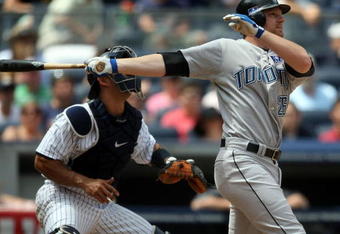 NEW YORK - JULY 04: Adam Lind #26 of the Toronto Blue Jays hits a two run home run in the sixth inning against the New York Yankees on July 4, 2009 at Yankee Stadium in the Bronx borough of New York City.  (Photo by Nick Laham/Getty Images)