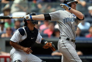 NEW YORK - JULY 04: Adam Lind #26 of the Toronto Blue Jays hits a two run home run in the sixth inning against the New York Yankees on July 4, 2009 at Yankee Stadium in the Bronx borough of New York City.  (Photo by Nick Laham/Getty Images)