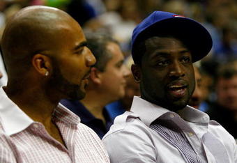 ORLANDO, FL - JUNE 11:  US Olympic teammates Carlos Boozer of the Utah Jazz and Dwyane Wade of the Miami Heat sit together at Game Four of the 2009 NBA Finals between the Los Angeles Lakers and the Orlando Magic on June 11, 2009 at Amway Arena in Orlando, Florida.  NOTE TO USER:  User expressly acknowledges and agrees that, by downloading and or using this photograph, User is consenting to the terms and conditions of the Getty Images License Agreement.  (Photo by Chris Graythen/Getty Images)