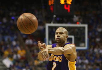 ORLANDO, FL - JUNE 14:  Derek Fisher #2 of the Los Angeles Lakers makes a pass against the Orlando Magic in Game Five of the 2009 NBA Finals on June 14, 2009 at Amway Arena in Orlando, Florida. The Lakers won 99-86. NOTE TO USER:  User expressly acknowledges and agrees that, by downloading and or using this photograph, User is consenting to the terms and conditions of the Getty Images License Agreement. (Photo by Elsa/Getty Images) 