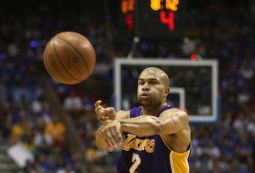 ORLANDO, FL - JUNE 14:  Derek Fisher #2 of the Los Angeles Lakers makes a pass against the Orlando Magic in Game Five of the 2009 NBA Finals on June 14, 2009 at Amway Arena in Orlando, Florida. The Lakers won 99-86. NOTE TO USER:  User expressly acknowledges and agrees that, by downloading and or using this photograph, User is consenting to the terms and conditions of the Getty Images License Agreement. (Photo by Elsa/Getty Images) 